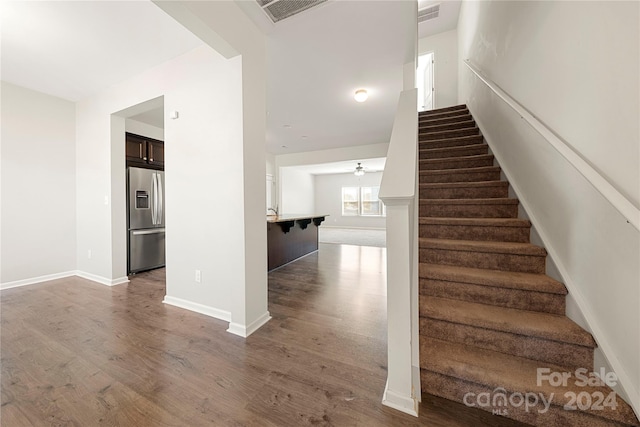 stairway featuring hardwood / wood-style floors