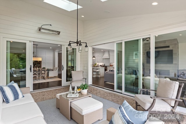 sunroom with vaulted ceiling with skylight