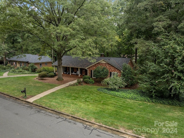 ranch-style home featuring a front yard