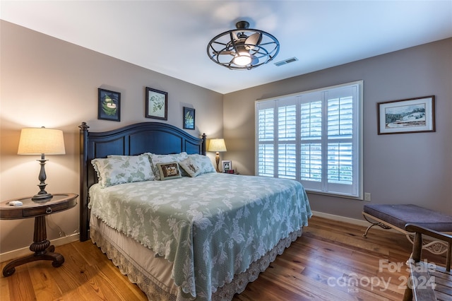 bedroom with hardwood / wood-style flooring