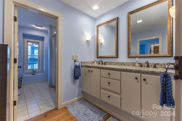 bathroom with hardwood / wood-style flooring and vanity