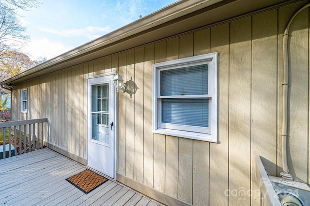 view of exterior entry with a wooden deck