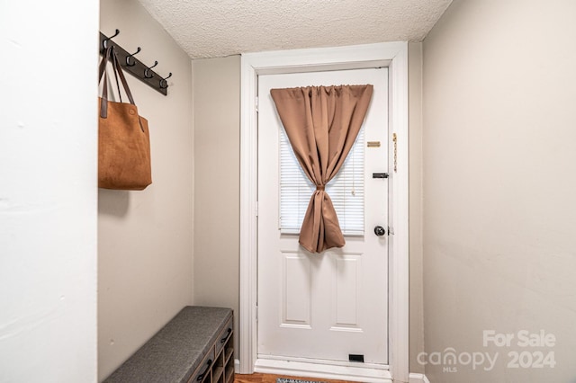 mudroom featuring a textured ceiling