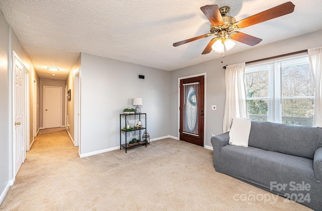 carpeted living room with a textured ceiling and ceiling fan