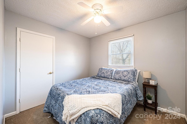 carpeted bedroom featuring a textured ceiling and ceiling fan