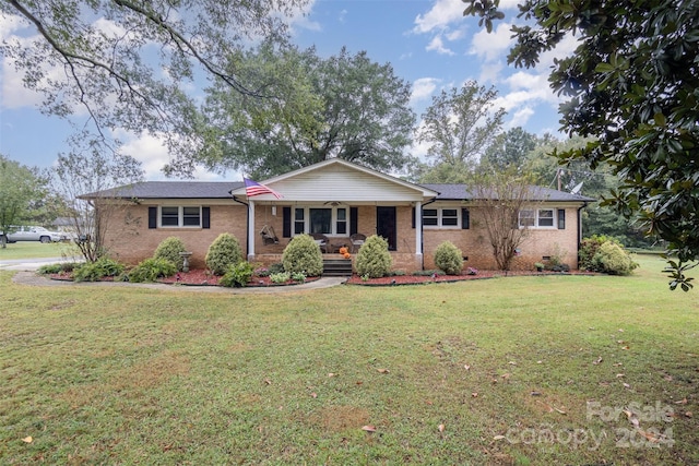 single story home featuring a porch and a front yard