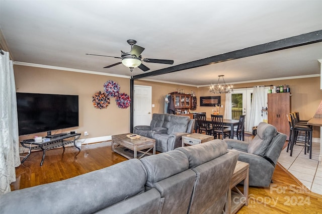 living room with ceiling fan with notable chandelier, light hardwood / wood-style flooring, and ornamental molding