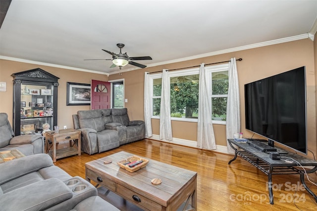 living room featuring wood-type flooring, ornamental molding, and ceiling fan