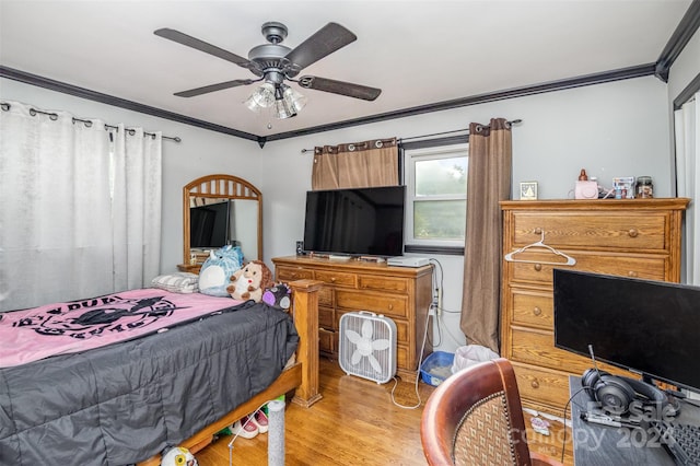 bedroom with light hardwood / wood-style floors, ornamental molding, and ceiling fan