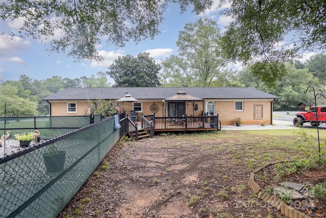 single story home featuring a wooden deck