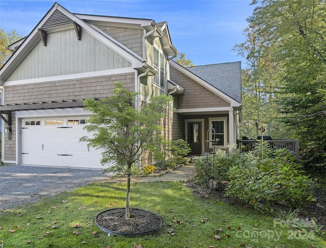 view of side of property with a garage and a yard