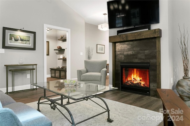 living room with vaulted ceiling and dark hardwood / wood-style flooring