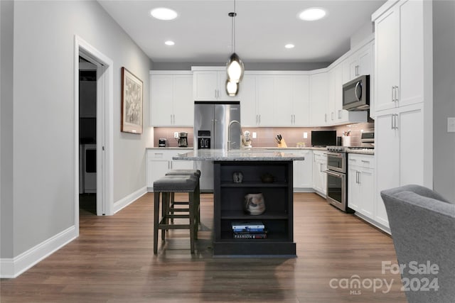 kitchen with a center island with sink, dark hardwood / wood-style flooring, stainless steel appliances, and white cabinets