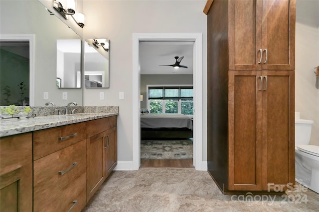 bathroom featuring ceiling fan, hardwood / wood-style flooring, toilet, and vanity