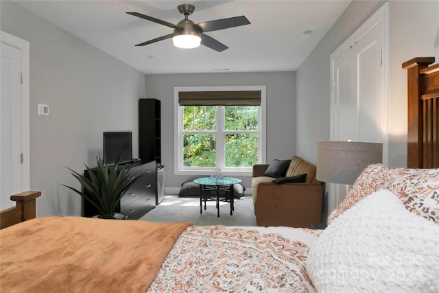 bedroom featuring light carpet and ceiling fan