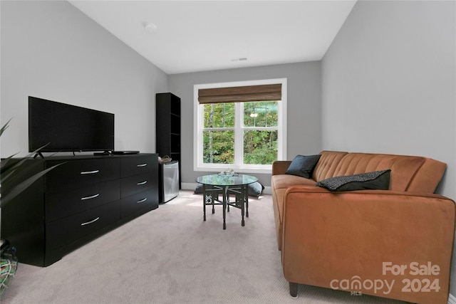 living room with lofted ceiling and light colored carpet