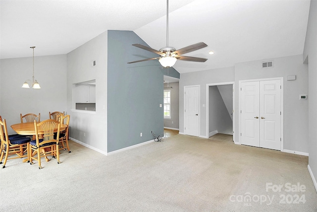 interior space with ceiling fan with notable chandelier and vaulted ceiling