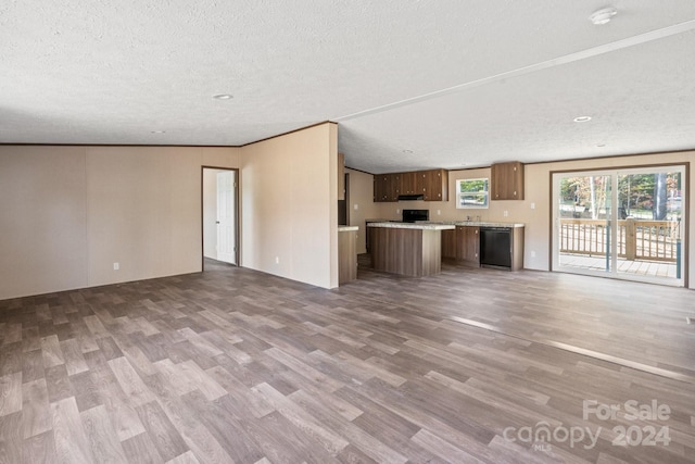 unfurnished living room featuring a textured ceiling and hardwood / wood-style floors