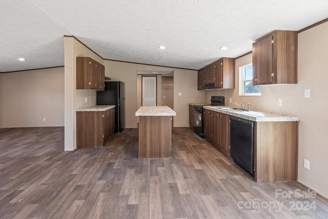 kitchen with black appliances, a center island, dark wood-type flooring, and a textured ceiling