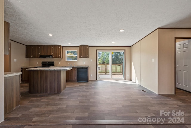 kitchen with range hood, black appliances, a center island, a textured ceiling, and dark hardwood / wood-style flooring