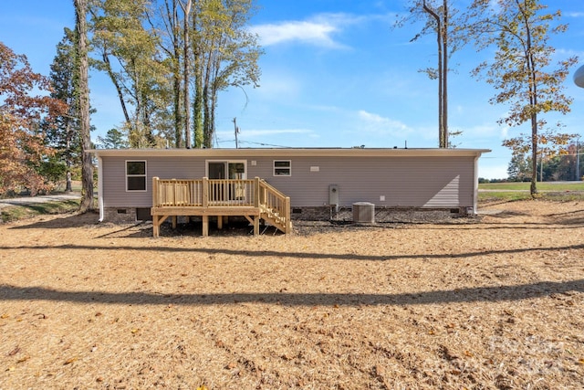 rear view of house featuring central AC and a wooden deck