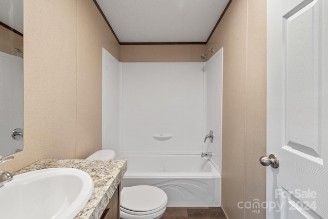 full bathroom featuring toilet, a textured ceiling, vanity, and washtub / shower combination