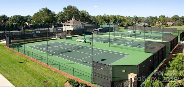 view of tennis court featuring fence