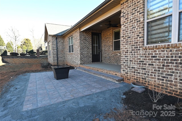 view of patio featuring ceiling fan and fence