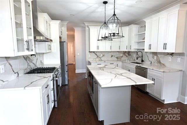 kitchen featuring pendant lighting, appliances with stainless steel finishes, glass insert cabinets, and white cabinets