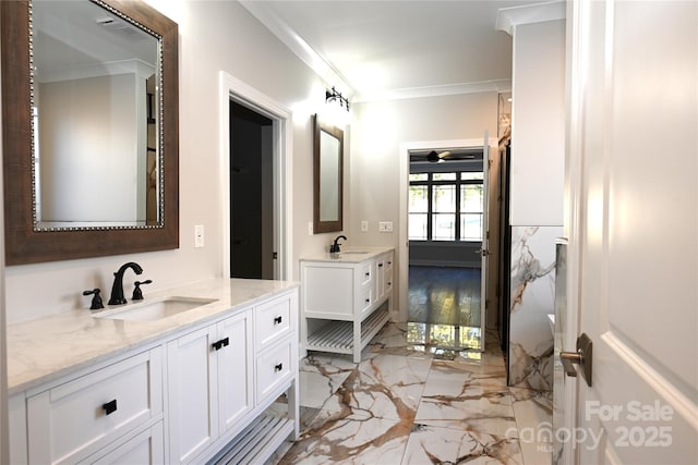 bathroom with a sink, marble finish floor, ornamental molding, and two vanities