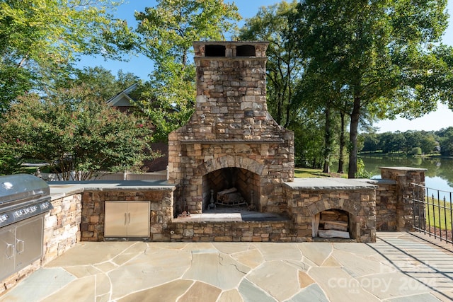 view of patio featuring area for grilling, grilling area, and a water view