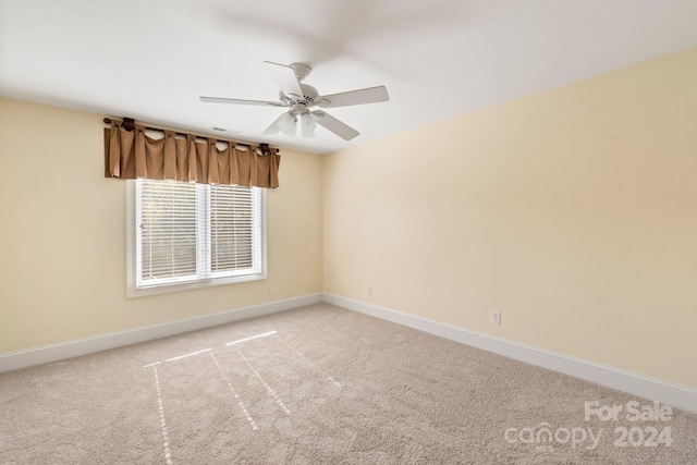 unfurnished room with ceiling fan and light colored carpet