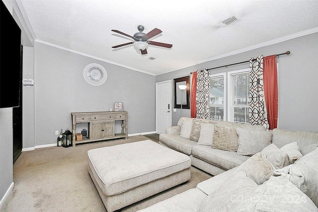 living room featuring ornamental molding, ceiling fan, light carpet, and a textured ceiling