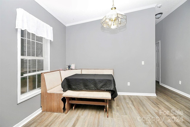 interior space featuring a notable chandelier, ornamental molding, and hardwood / wood-style flooring