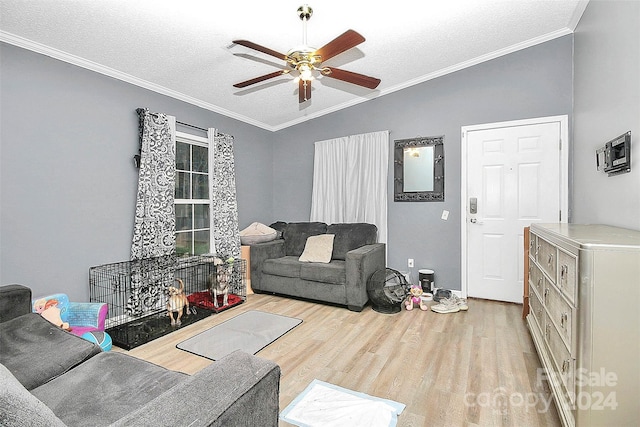 living room featuring ceiling fan, lofted ceiling, a textured ceiling, light wood-type flooring, and crown molding