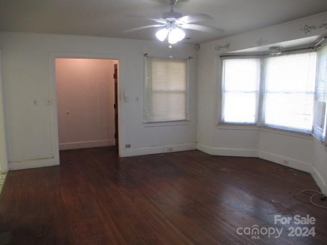 spare room featuring ceiling fan and dark hardwood / wood-style floors