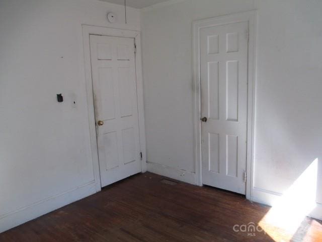 spare room featuring dark hardwood / wood-style flooring