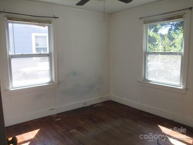 unfurnished room featuring ceiling fan and dark wood-type flooring