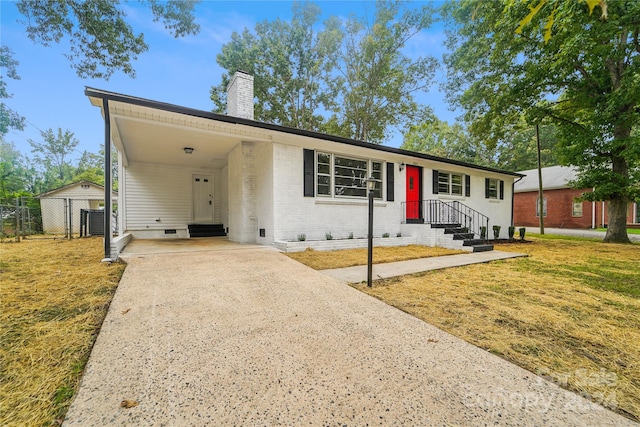 single story home featuring a front lawn, central AC unit, and a carport