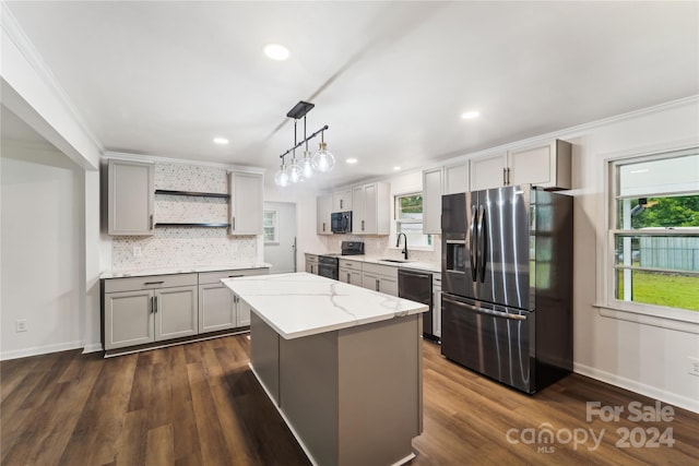 kitchen with black appliances, gray cabinetry, a kitchen island, and pendant lighting