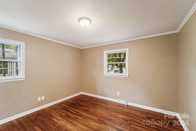 empty room with wood-type flooring, plenty of natural light, and crown molding