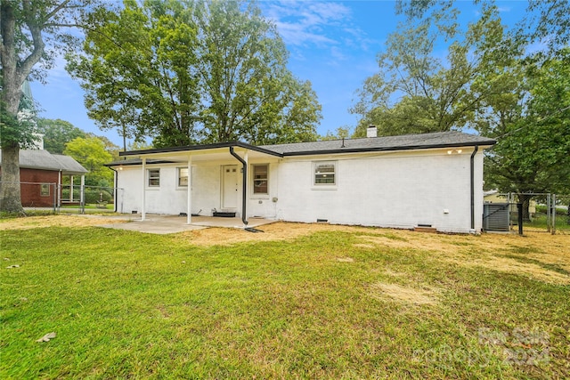 back of property featuring cooling unit, a lawn, and a patio