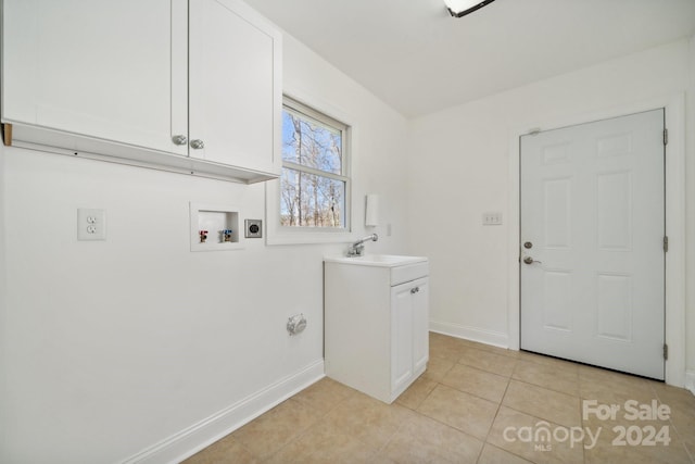 laundry room with cabinets, hookup for a washing machine, light tile patterned floors, and sink