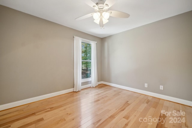 empty room featuring ceiling fan and light hardwood / wood-style floors