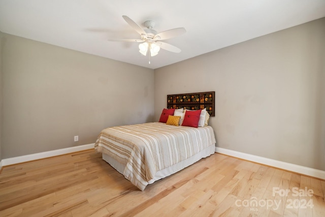 bedroom with ceiling fan and light hardwood / wood-style flooring