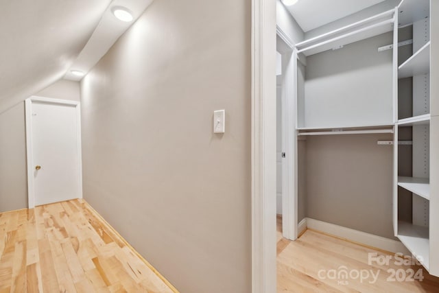 interior space featuring hardwood / wood-style floors and lofted ceiling