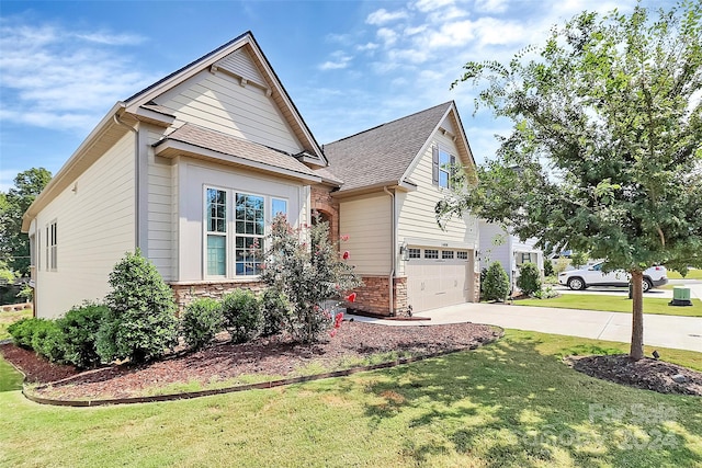 view of front of house featuring a front lawn and a garage