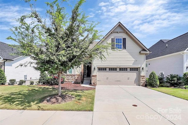 view of front of property featuring a garage and a front lawn