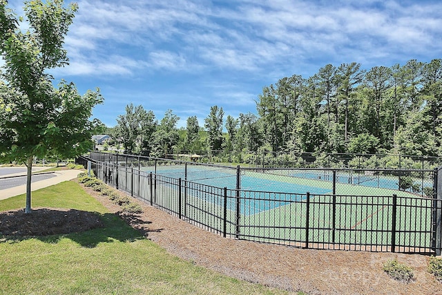 view of sport court featuring a yard