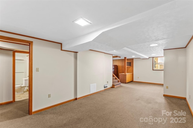 basement featuring carpet flooring and crown molding